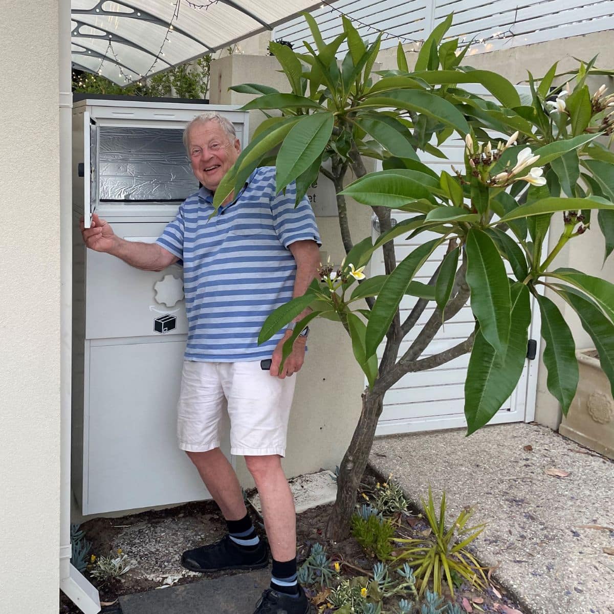 Richard's dad collecting a delivery from his parcel box at his Perth home.